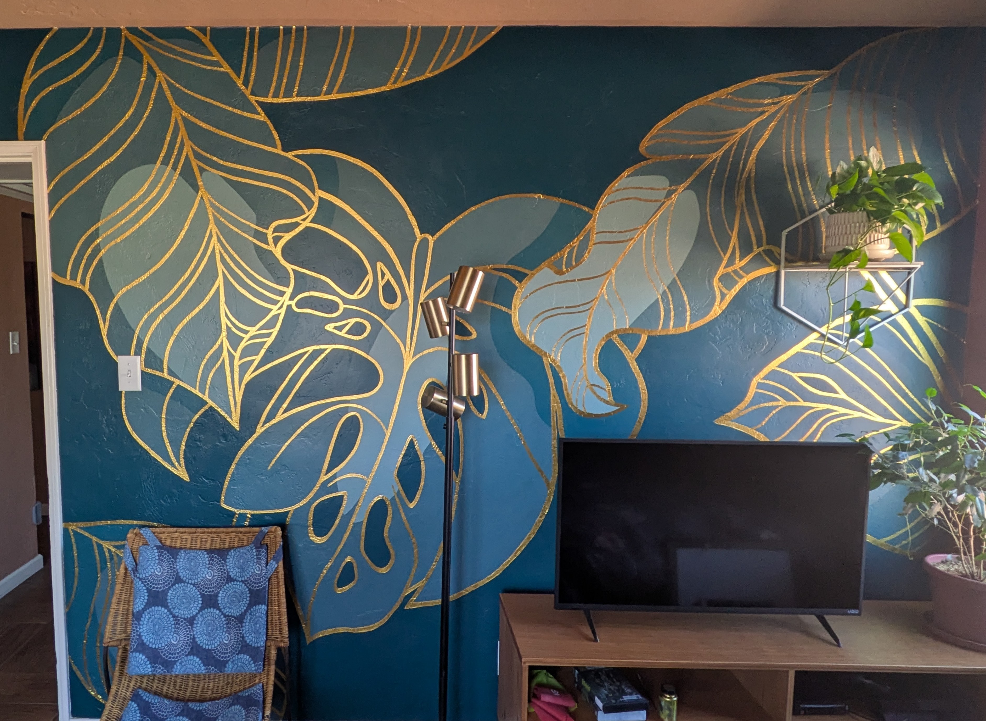 A green and white mural showing California poppies in the negative